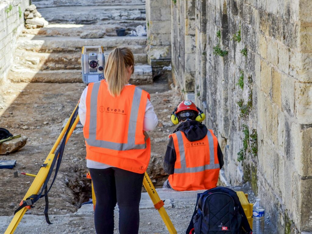 Professionals conducting an archaeological survey at historic ruins in Périgueux, France.